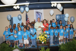 Celebration Board Member Pat Marsh presents a check for $2500 to Christy Parsons and the Bedford County Boys & Girls Club members from the Gulf Coast Charity Celebration.